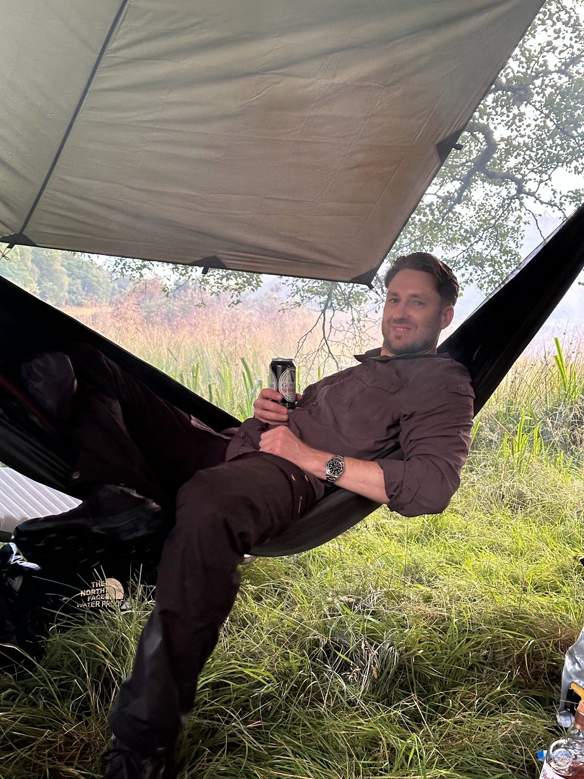 Me in the hammock with a beer, before the rain worked its way down the ropes and into the silk