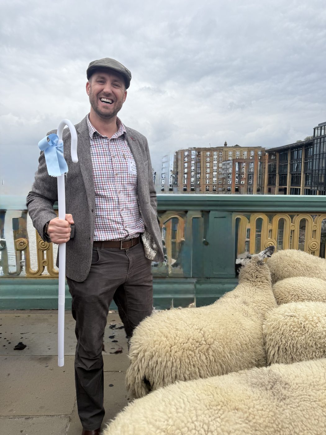 Flat cap, tweed jacket and a shepherd’s crook with a blue ribbon: me laughing on Southwark Bridge, with the sheep alongside