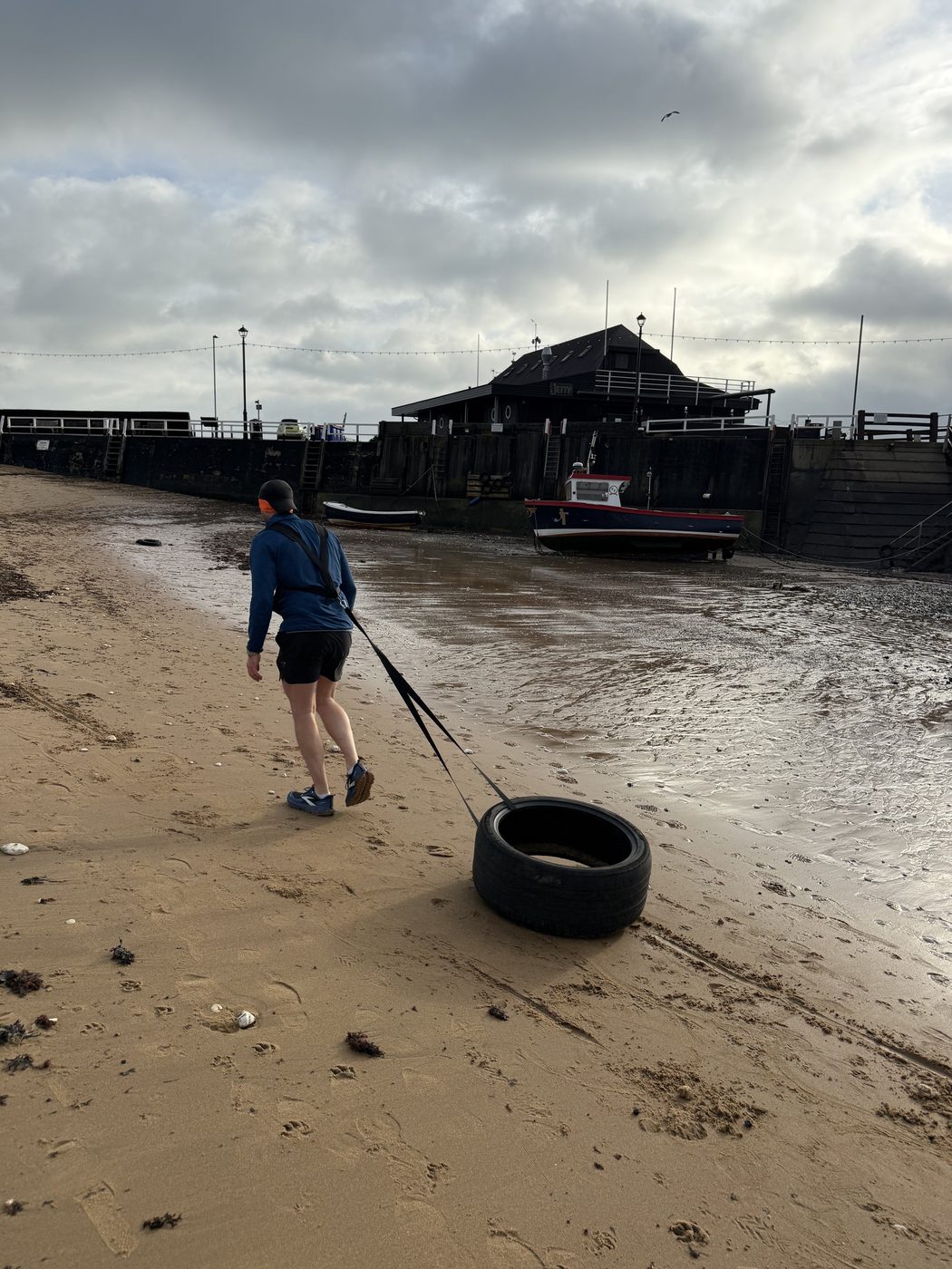 Dragging a tyre on the sand in place of a sled